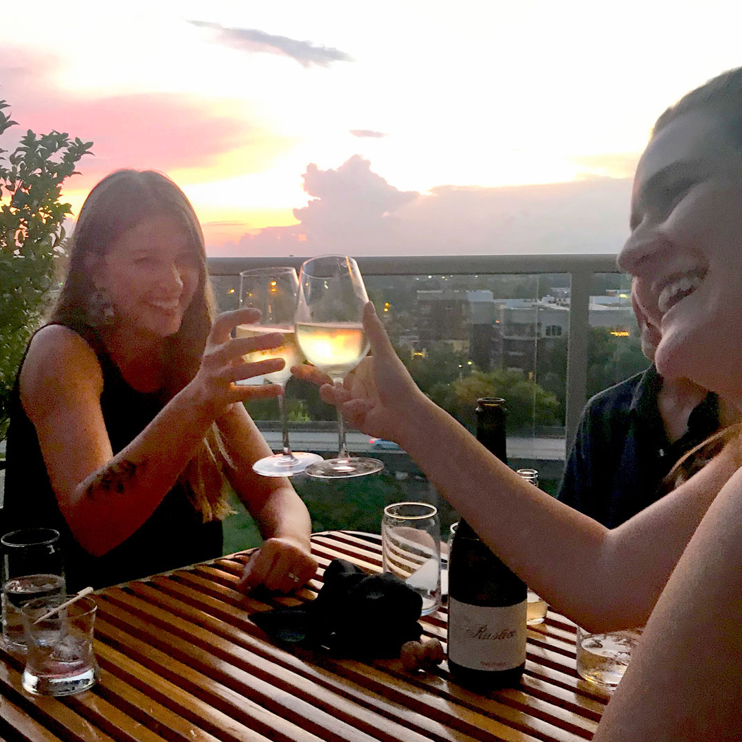 Friends toasting at UP on the Roof in Downtown Greenville, SC