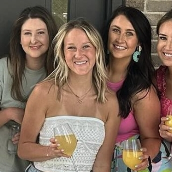 Group of ladies enjoying brunch and bottomless mimosas at UP on the Roof