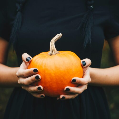 Halloween woman holding a pumpkin