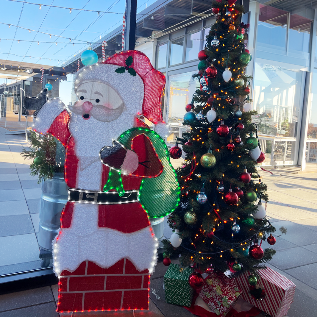 A lit snowman and Christmas tree at Elf'd UP in Anderson