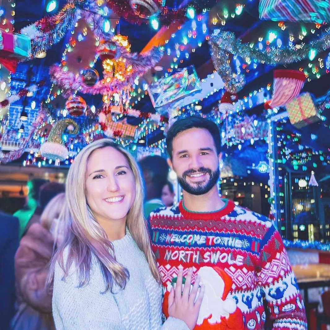 A joyful couple under the Elf'd UP decor